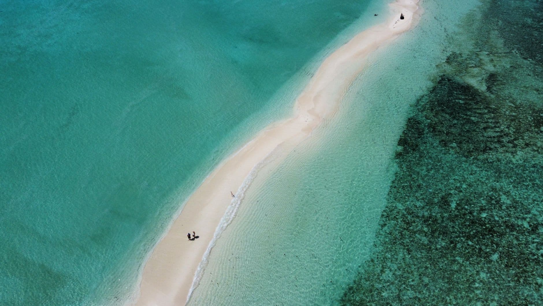 A bare sandbank surrounded by turquoise water